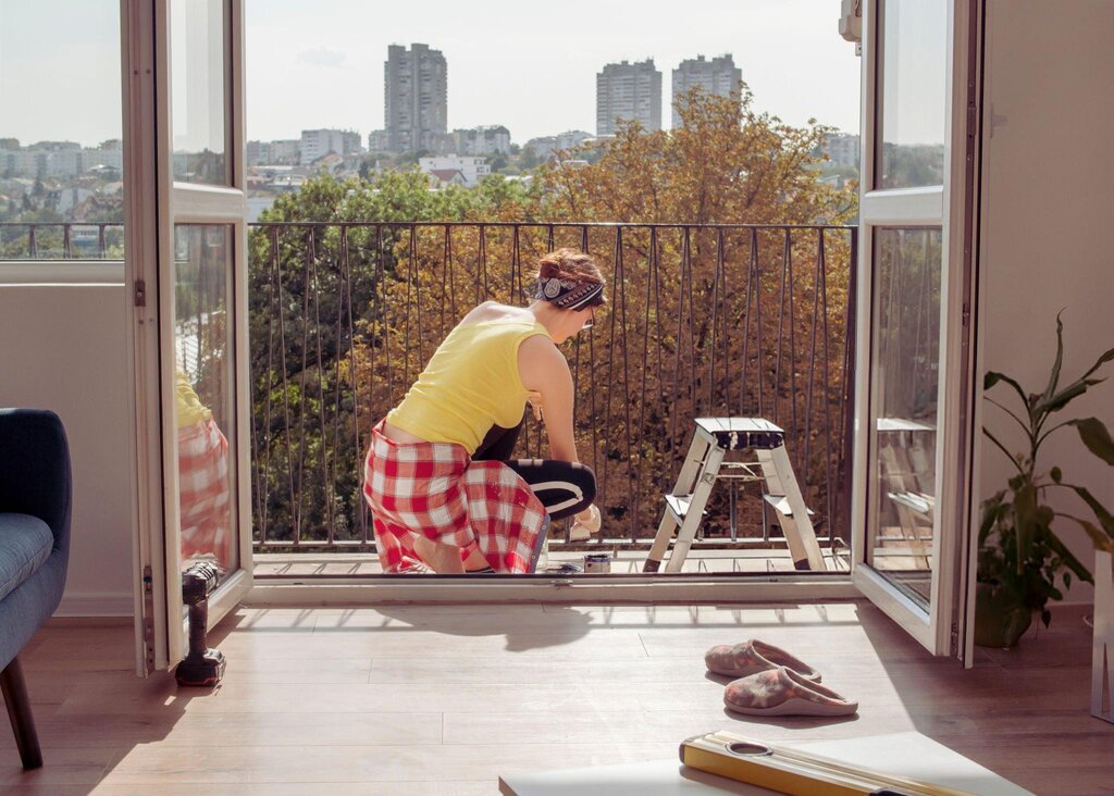 woman painting the balcony